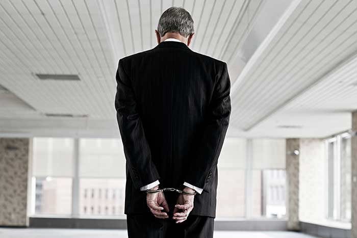 Businessman in handcuffs